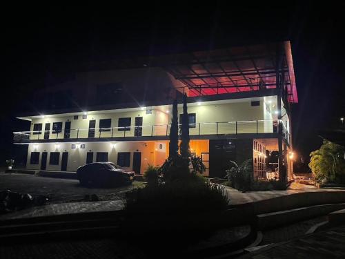 a building at night with a car parked in front at hacienda hotel texas in Durania