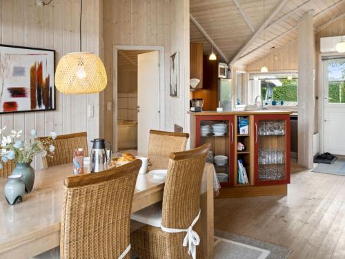 a dining room with a table and chairs at Holiday Home Thorke - 200m from the sea by Interhome in Nysted