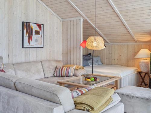 a living room with a couch and a table at Holiday Home Thorke - 200m from the sea by Interhome in Nysted