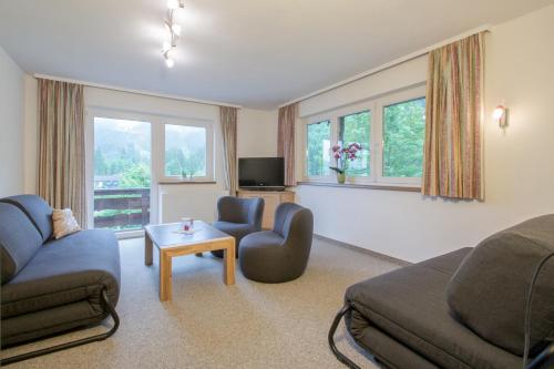 a living room with a couch and a table at Ferienwohnung Pension Tirol in Bichlbach
