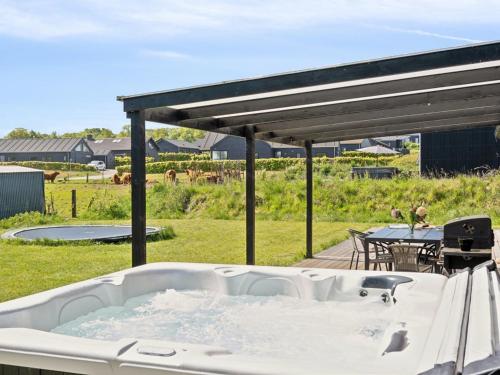 a bath tub in a yard with a table at Holiday Home Jul - 300m from the sea by Interhome in Haderslev