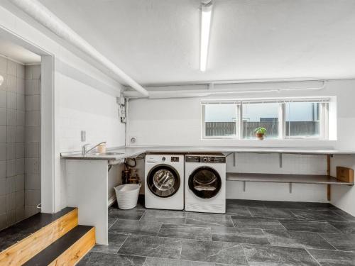 a laundry room with a washer and dryer in it at Holiday Home Ullakarin - 200m from the sea by Interhome in Thyborøn