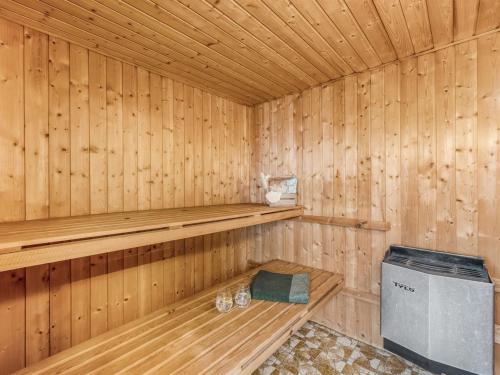 a wooden sauna with a bench in it at Holiday Home Ullakarin - 200m from the sea by Interhome in Thyborøn