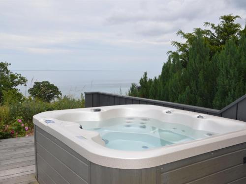 a jacuzzi tub on the deck of a house at Holiday Home Seetje - 200m from the sea by Interhome in Allinge