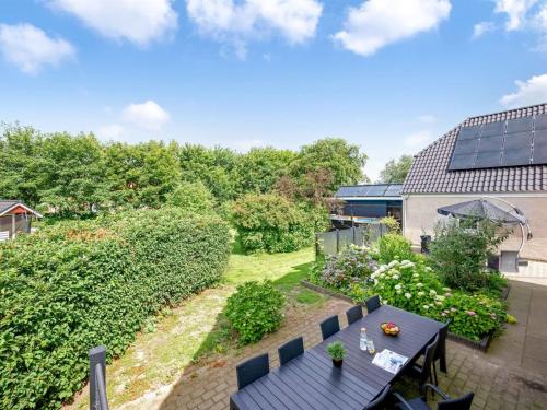 an image of a garden with a table and chairs at Holiday Home Amma - 21km from the sea by Interhome in Bredebro