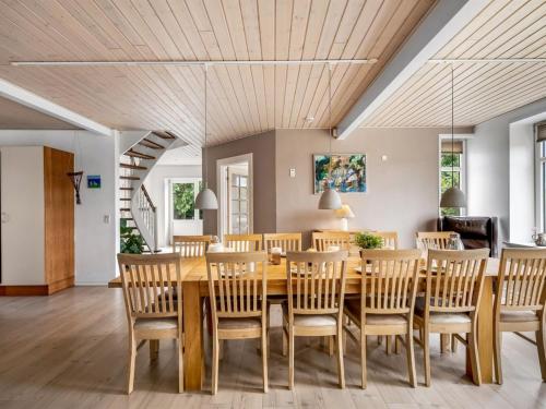 a dining room with a wooden table and chairs at Holiday Home Amma - 21km from the sea by Interhome in Bredebro