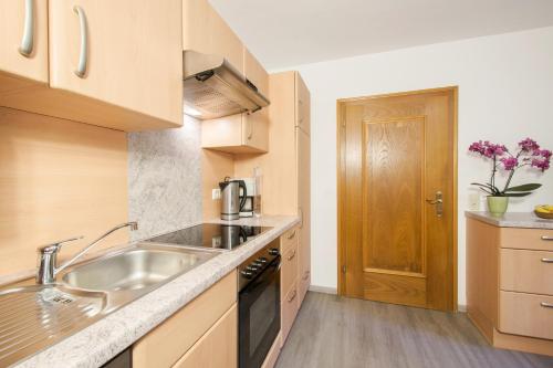 a kitchen with a sink and a counter top at Ferienwohnung Pension Tirol in Bichlbach