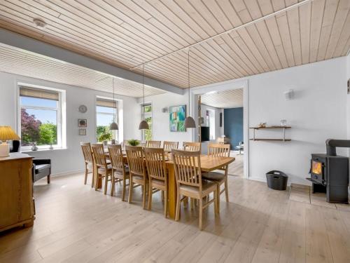 a dining room with a table and chairs at Holiday Home Amma - 21km from the sea by Interhome in Bredebro
