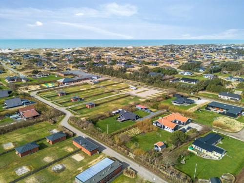an aerial view of a suburb with houses and the ocean at Holiday Home Torhild - 700m from the sea by Interhome in Ringkøbing