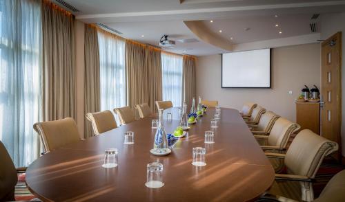 a conference room with a long wooden table and chairs at Maldron Hotel & Leisure Centre Limerick in Limerick