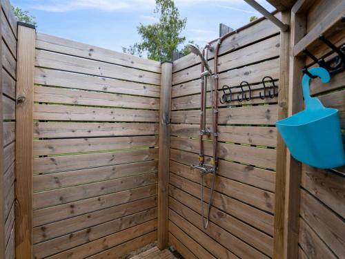 a wooden privacy fence with a blue bucket at Holiday Home Anett - 375m from the sea by Interhome in Fårevejle