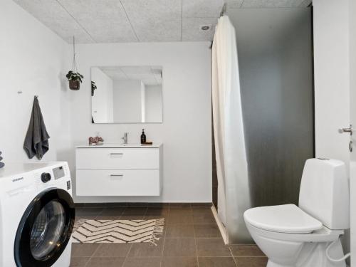 a bathroom with a washer and dryer in it at Holiday Home Cresta - 1-4km from the sea by Interhome in Løkken
