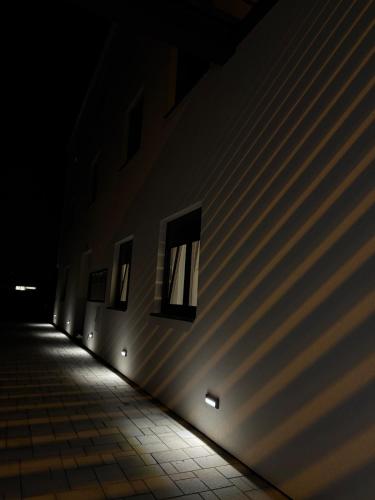 a dark hallway with windows on the side of a building at Apartman Dukat- Luksuzna novogradnja u srcu Vinkovaca s parkingom in Vinkovci