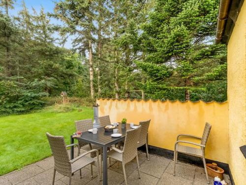 a table and chairs sitting on a patio at Holiday Home Birtir - 750m from the sea by Interhome in Hanstholm
