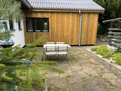 a patio with a table and chairs in front of a building at Holiday Home Alica - 200m from the sea by Interhome in Neksø