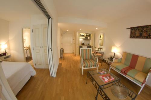 a living room with a bed a couch and a table at STRAVINSKY Apartments Avignon - Get our Last best deals ! in Avignon