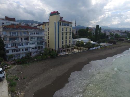 a building on the shore of a beach next to the water at Vurna Butik Hotel in Trabzon