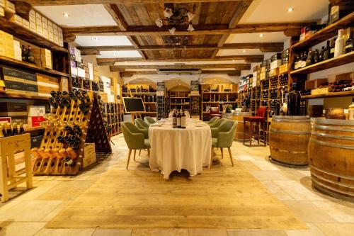 a room with a table and chairs and wine barrels at Hotel Lac Salin Spa & Mountain Resort in Livigno