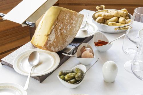 a table topped with plates and bowls of food and eggs at Hotel Lac Salin Spa & Mountain Resort in Livigno