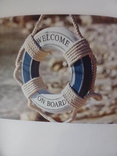 a necklace with a welcome on board label on a rope at Rose Cottage-4 BED HOUSE FOR CONTRACTORS & FAMILIES Close to M6, J10-NO PARTIES ALLOWED in Walsall