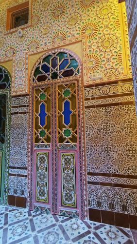 a colorful door in a room with a wall at Riad Las mil y una noches 2 Tetuan in Tetouan