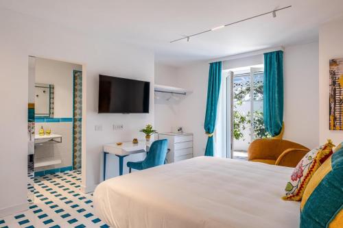 a hotel room with a bed and a bathroom at Villa Coralia Luxury Suite in Amalfi Coast, Sorrento, Italia in Sorrento