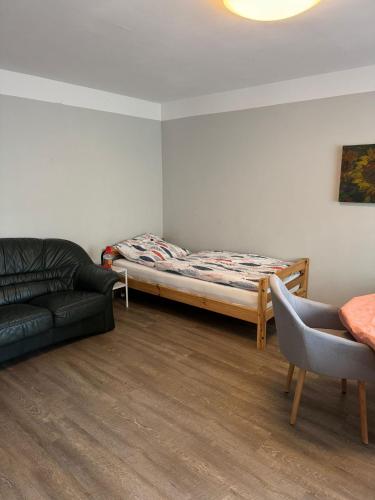 a living room with a bed and a couch at Monteurswohnung Rothentor4 in Steffin