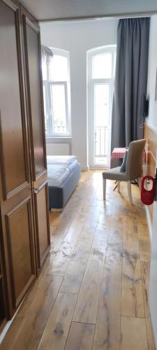 a living room with a bed and a wooden floor at Hotel Zur Fähre in Boppard