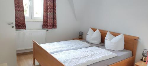 a bedroom with a bed with white sheets and pillows at Hotel Zur Fähre in Boppard