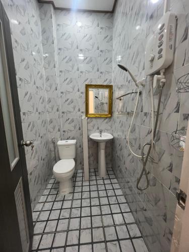 a bathroom with a toilet and a sink at Manichan guesthouse in Pakse