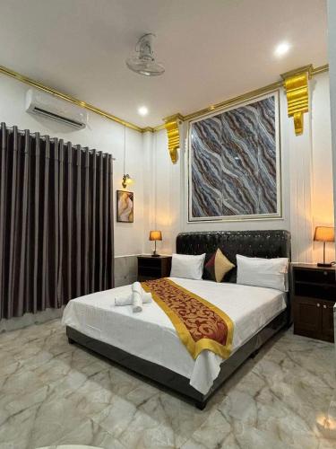 a bedroom with a bed and a large window at Manichan guesthouse in Pakse