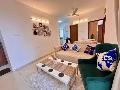 a living room with a couch and a coffee table at Resort style Girvansh Residence2Bhk Adora De Goa By Amoret Homes in Chicalim