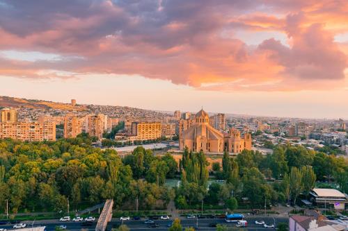 an old church in a city with a sunset at Sunset Apart-Hotel in Yerevan