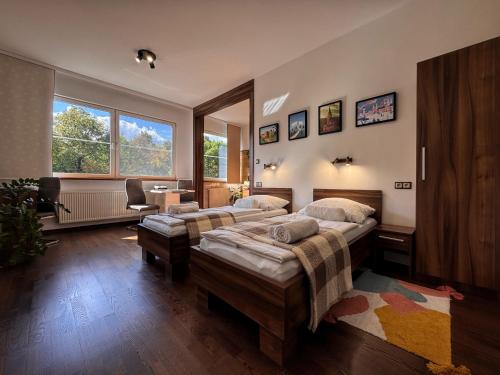 a bedroom with two beds and a desk in it at L69 Apartments - Angel's Apartment in Banská Bystrica