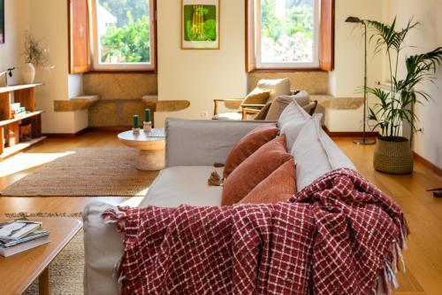 a living room with a couch with pillows on it at Casa da Câmara in Tondela