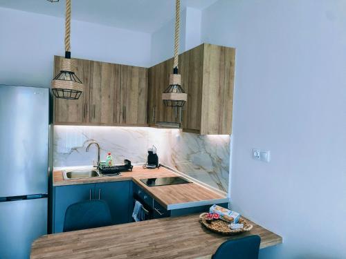 a kitchen with a sink and a counter top at EriZen Jacuzzi suites in Keramotí