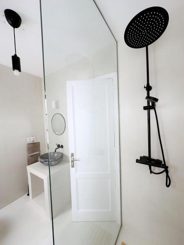 a bathroom with a glass door and a mirror at Casa Rofe in Playa Honda
