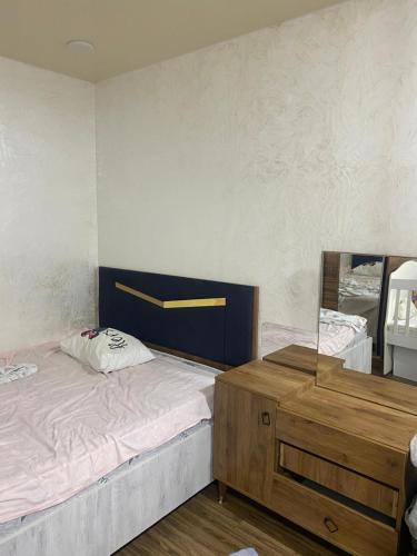 a bedroom with a large bed and a mirror at mamuhouse 