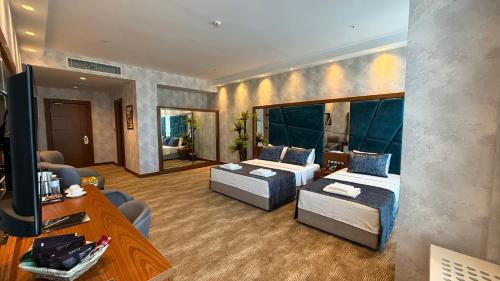 Ένα ή περισσότερα κρεβάτια σε δωμάτιο στο Alsancak Prime Hotel Konya