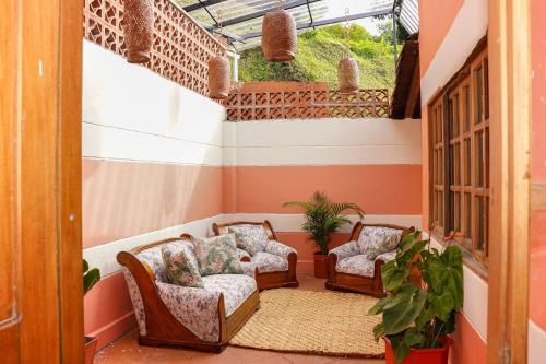 a room with two chairs and a window at Escape to Nature in Copacabanas Hidden Gem in Copacabana