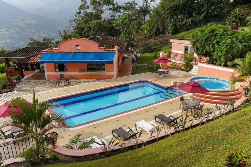 a swimming pool in front of a house at Escape to Nature in Copacabanas Hidden Gem in Copacabana