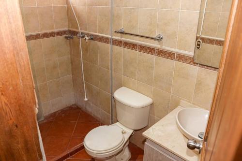 a bathroom with a toilet and a sink at Escape to Nature in Copacabanas Hidden Gem in Copacabana