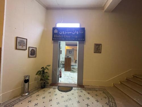 a hallway with a blue sign in a building at One Season Hotel in Cairo
