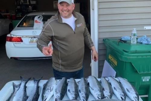 a man standing in front of a table of fish at Restored historic home near ND and Amish Country in Elkhart