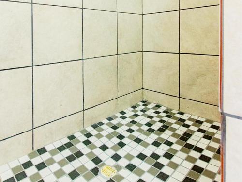 a corner of a bathroom with a checkered floor at Wiggins Self Catering in Jacobs Bay