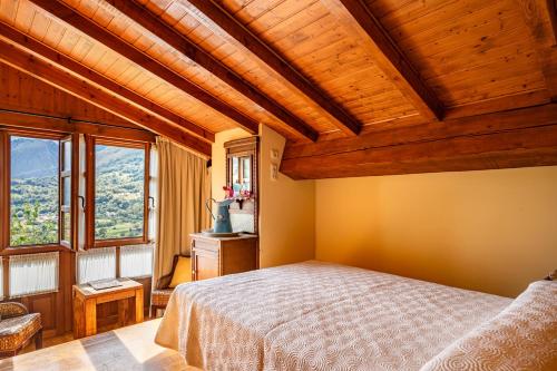 a bedroom with a bed with a wooden ceiling at Casas de Para Casa de Abajo in Para