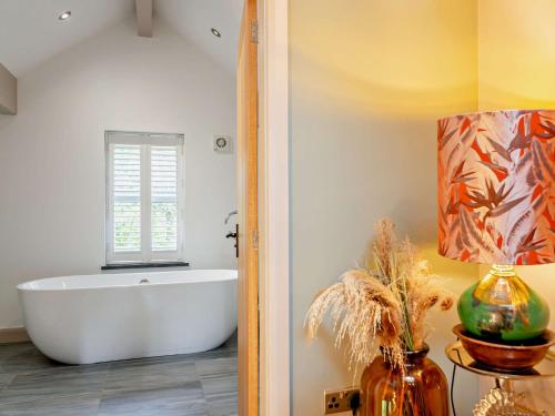 a bathroom with a white tub and a window at 3 bed in Harrogate 77577 in Timble