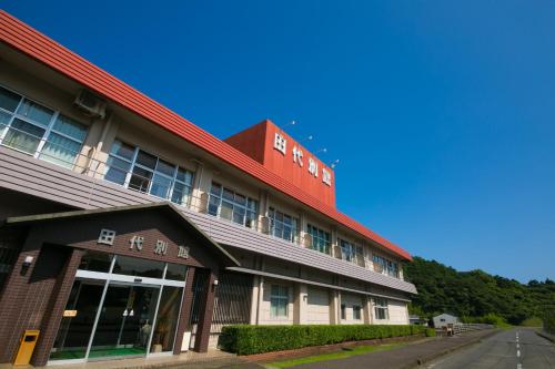 a building with a red roof on a street at Tashiro Annex in Yakushima