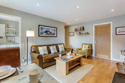 a living room with a couch and a table at 1 Bed in Newtonmore oc-b32417 in Newtonmore