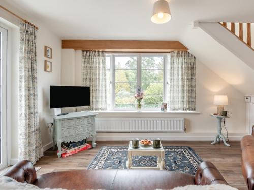 a living room with a large window and a television at 2 Bed in Godshill 96127 in Godshill